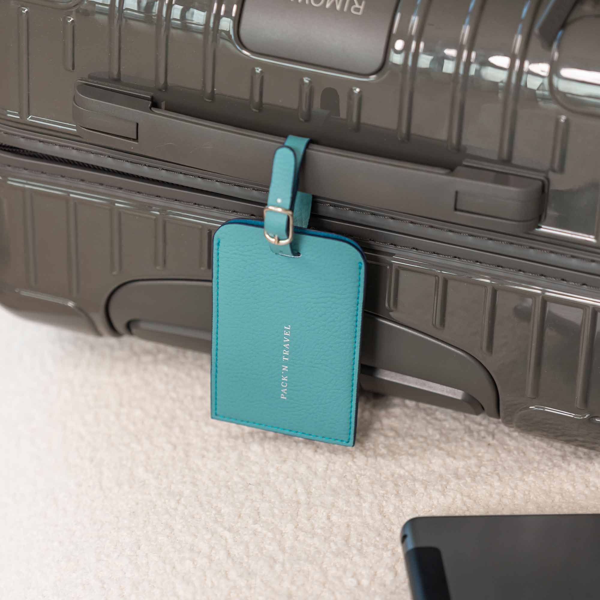 Durable turquoise vegan leather luggage tag crafted to endure every trip.
