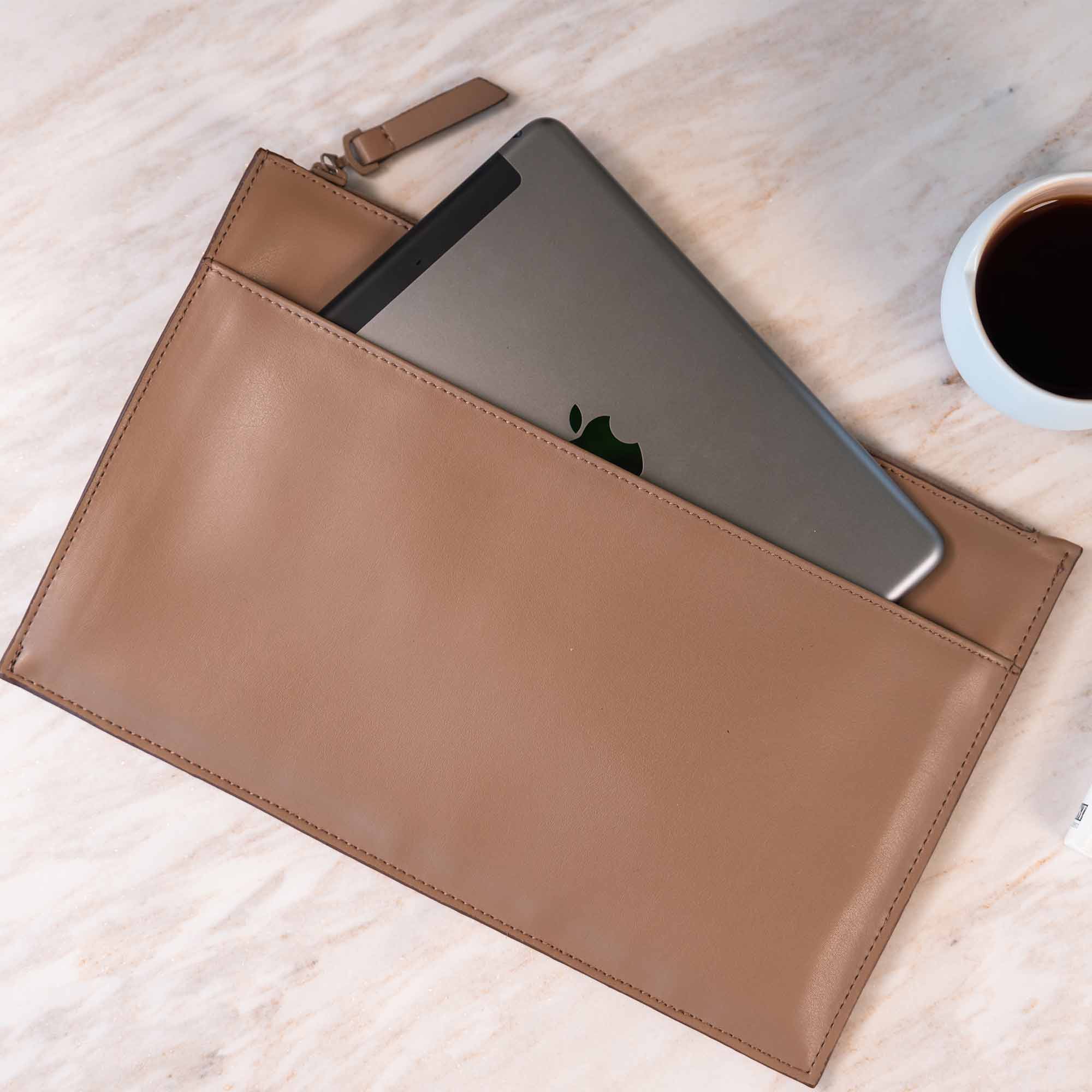 Elegant beige vegan leather clutch crafted for graceful and versatile styling.