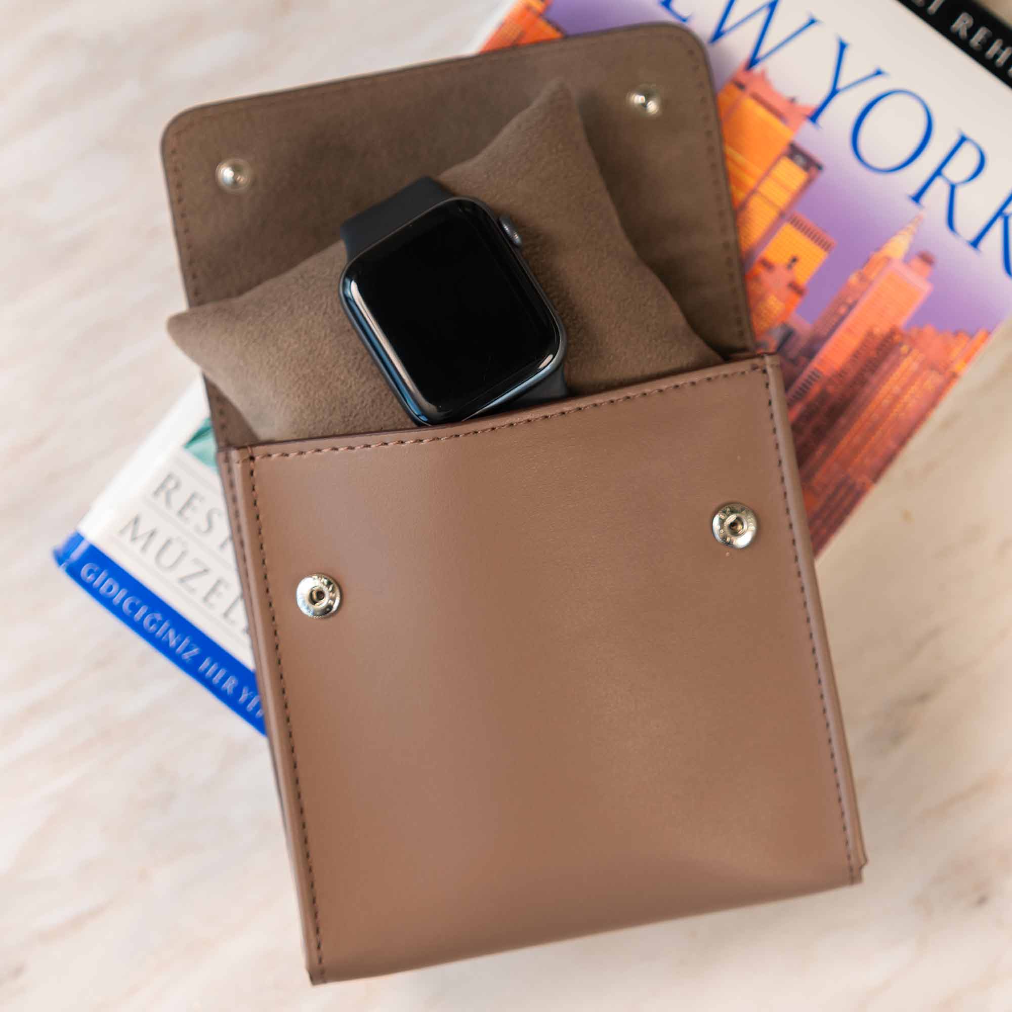 Elegant beige vegan leather watch case for refined and secure travel.