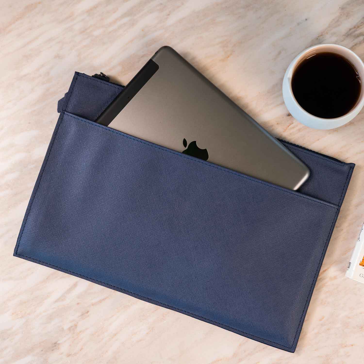 Elegant dark blue vegan leather clutch that balances fashion and function.