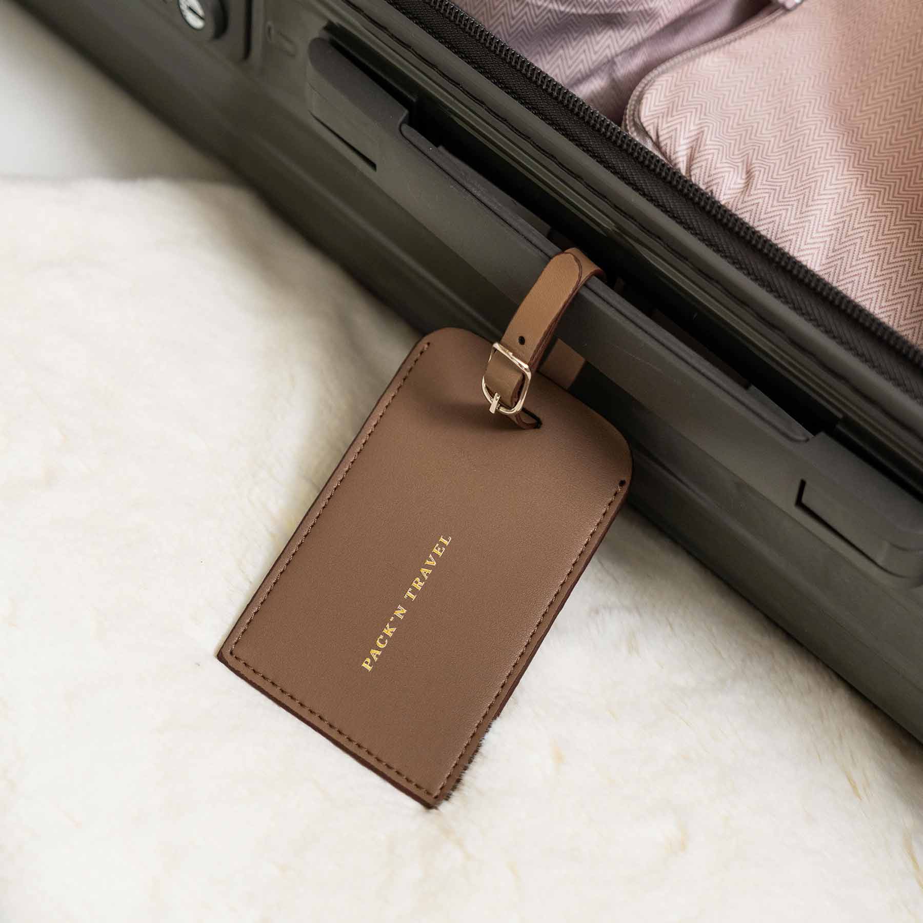 Luxury beige vegan leather luggage tag offers timeless style for travel needs.