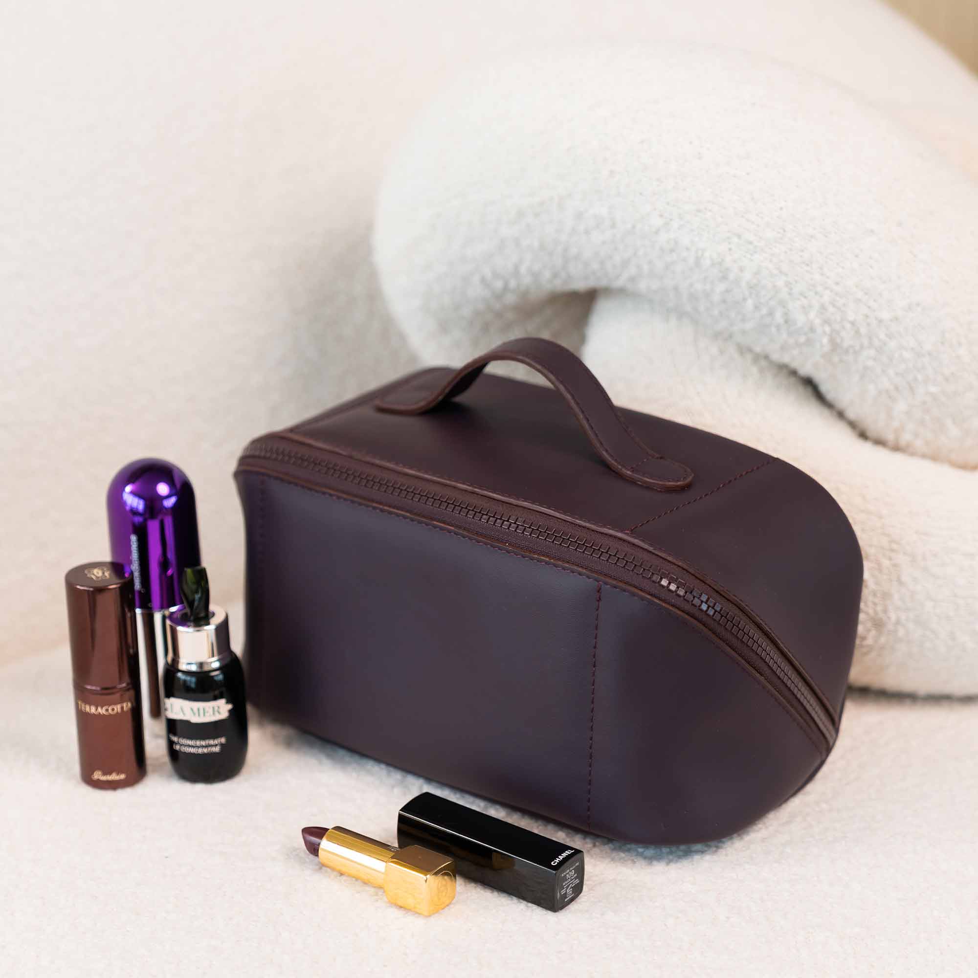 Practical deep plum vegan leather make-up bag offering ease and function.