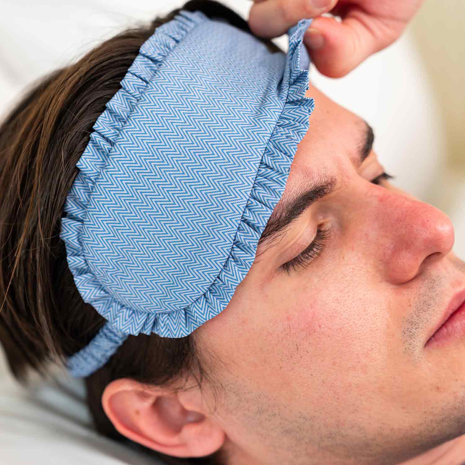 Stylish blue vegan leather sleep mask designed for rest and modern travel looks.