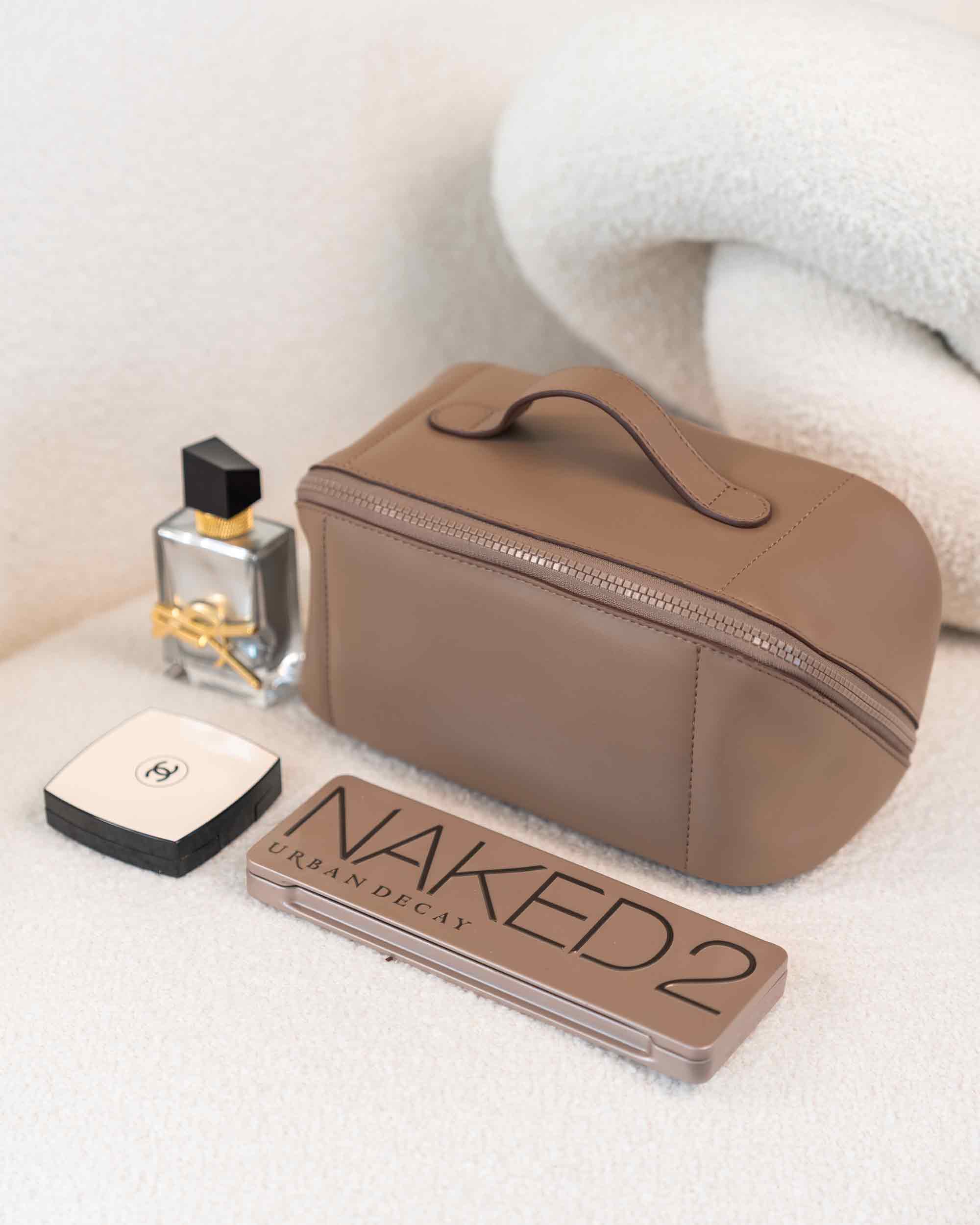 Sustainable beige vegan leather make-up bag offering chic and eco-friendly organisation.