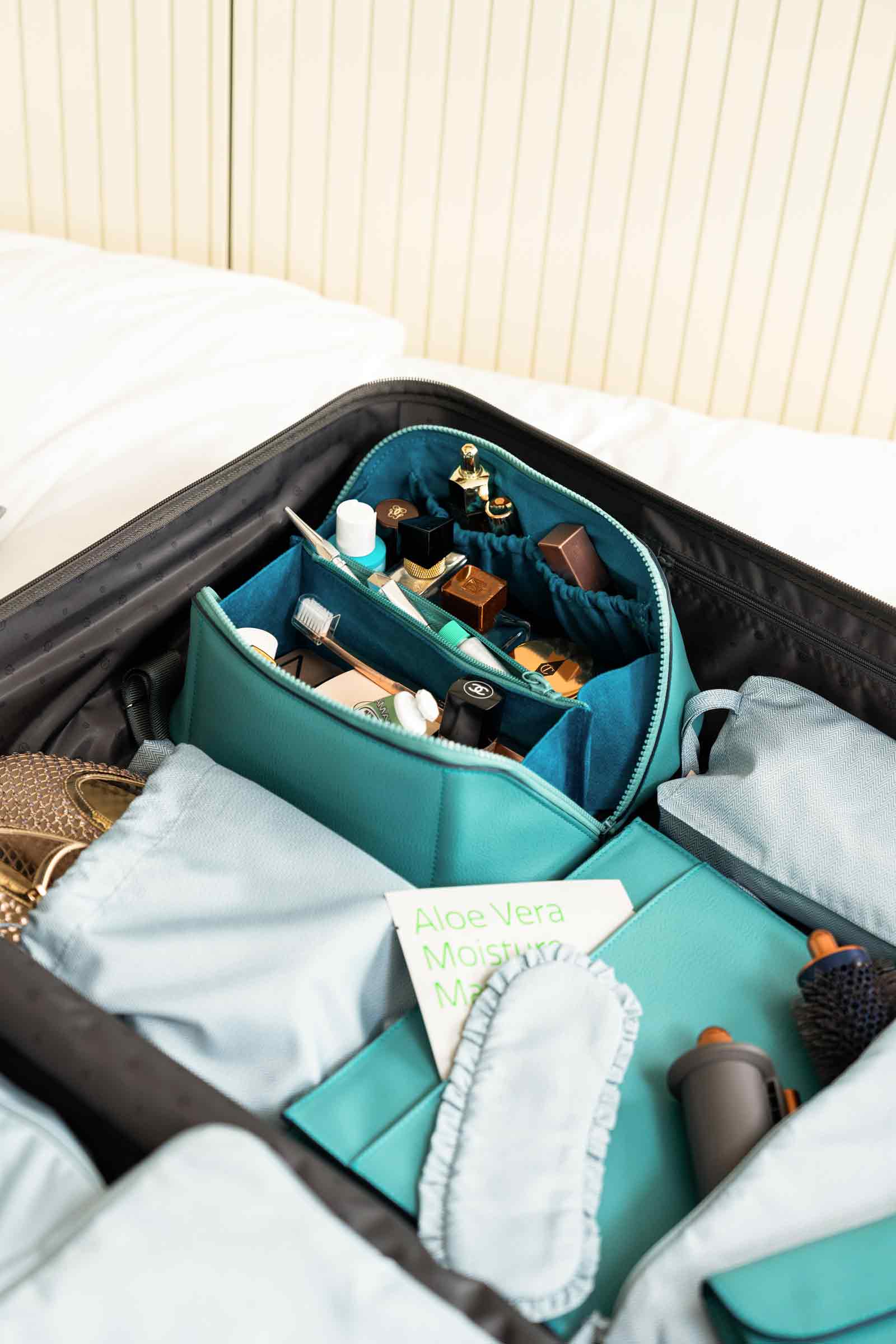 Sustainable turquoise vegan leather make-up bag offering vibrant style and organisation.